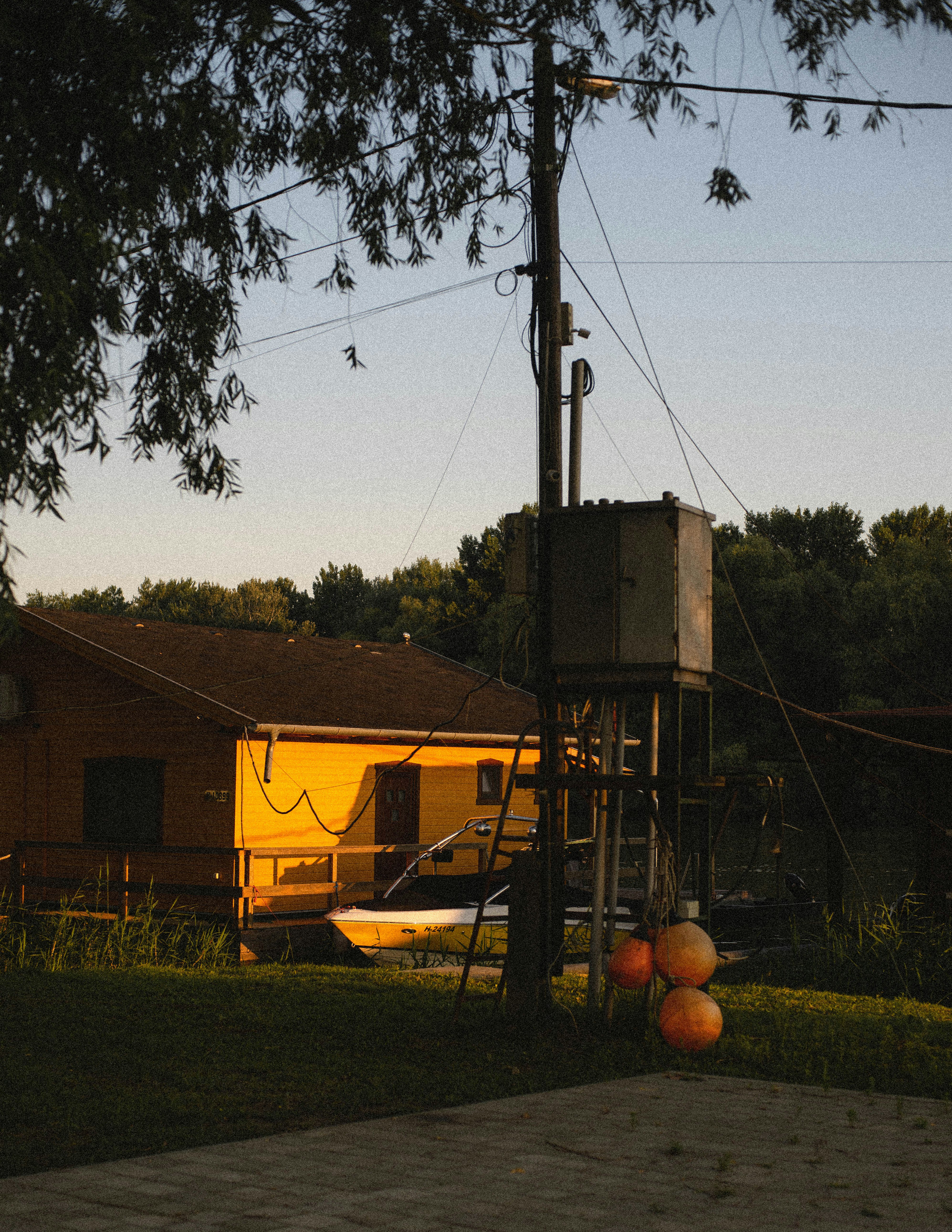 brown wooden house near green grass field during daytime